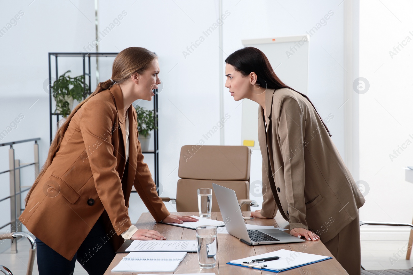 Photo of Emotional colleagues arguing in office. Toxic work environment