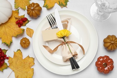 Beautiful autumn place setting with blank card and decor for festive dinner on table, flat lay