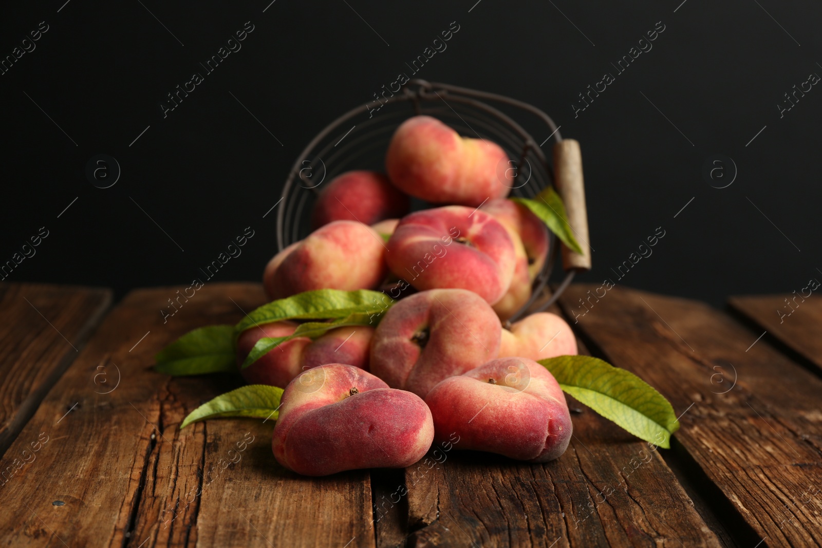 Photo of Fresh ripe donut peaches on wooden table