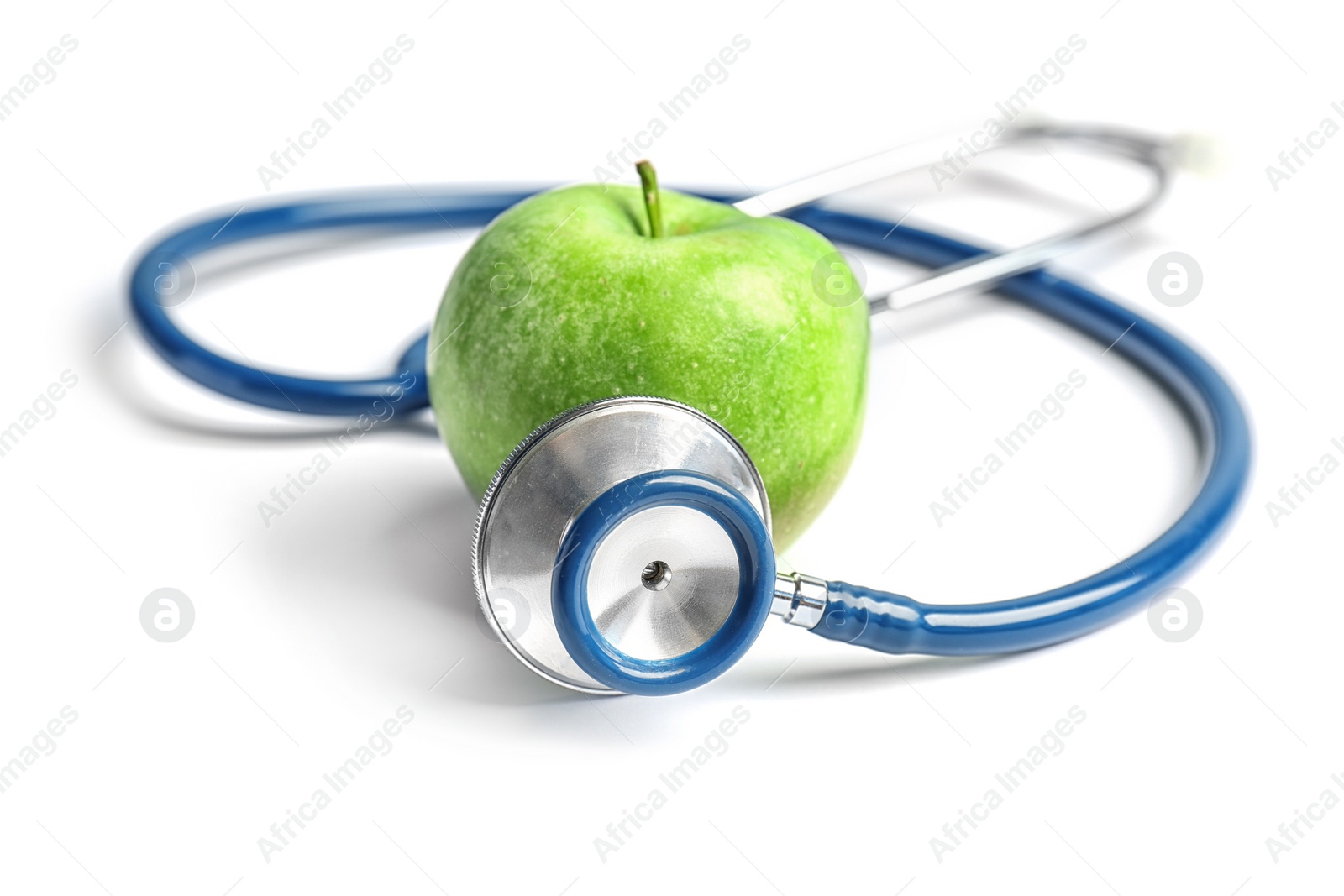 Photo of Stethoscope and apple on light background. Medical equipment