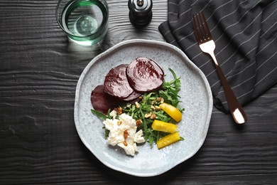 Plate with delicious beet salad on table, top view