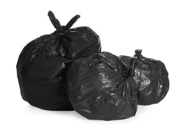 Photo of Black trash bags full of garbage on white background