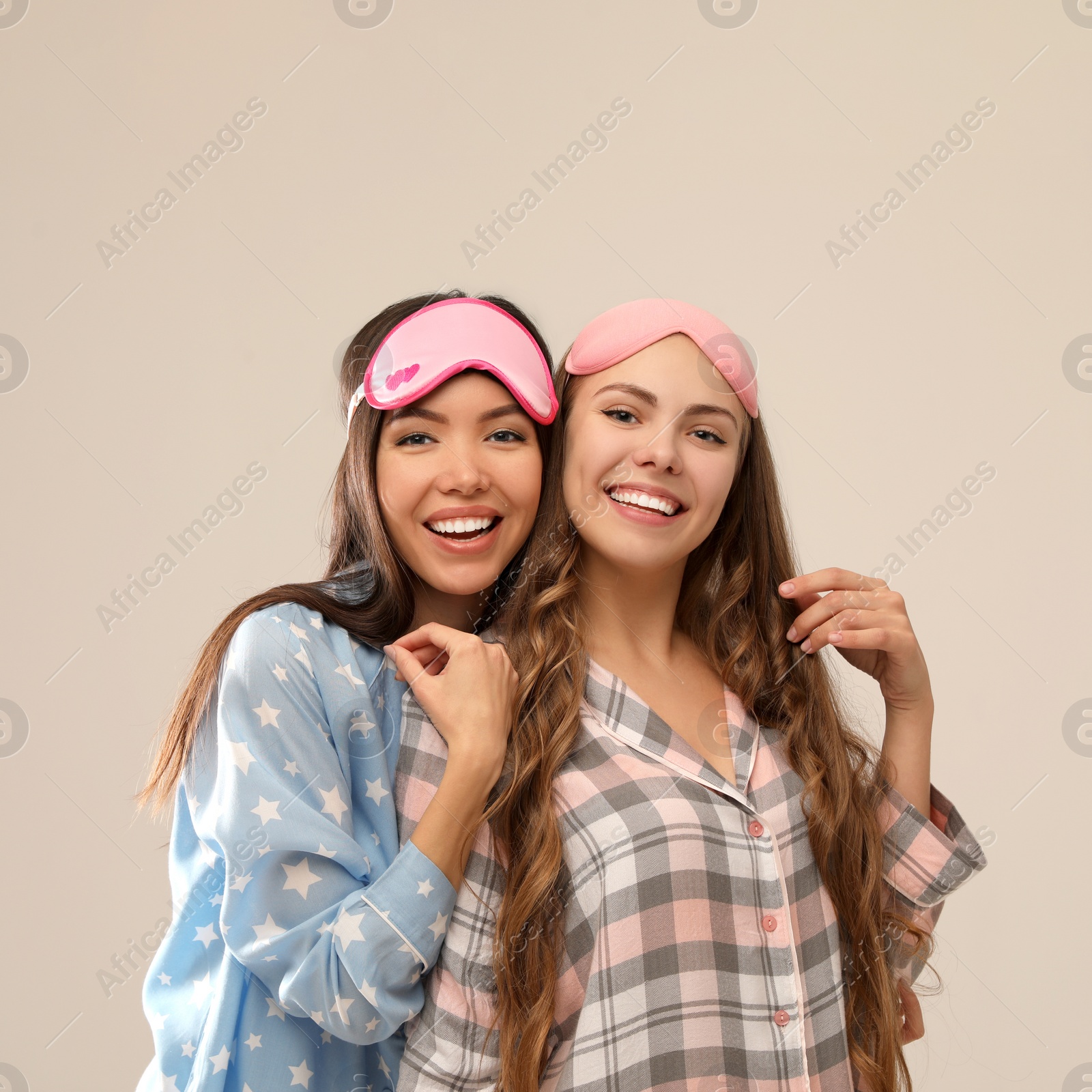 Photo of Beautiful women in pajamas on beige background. Bedtime