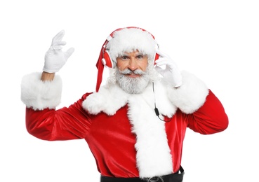 Photo of Santa Claus listening to Christmas music on white background