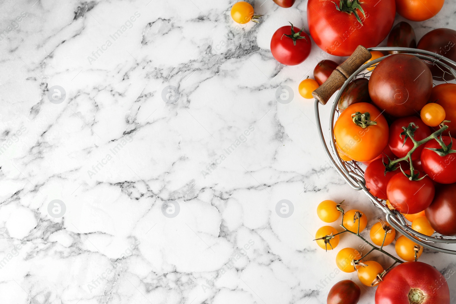 Photo of Flat lay composition with fresh ripe tomatoes on marble table, space for text