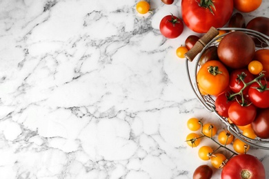 Flat lay composition with fresh ripe tomatoes on marble table, space for text