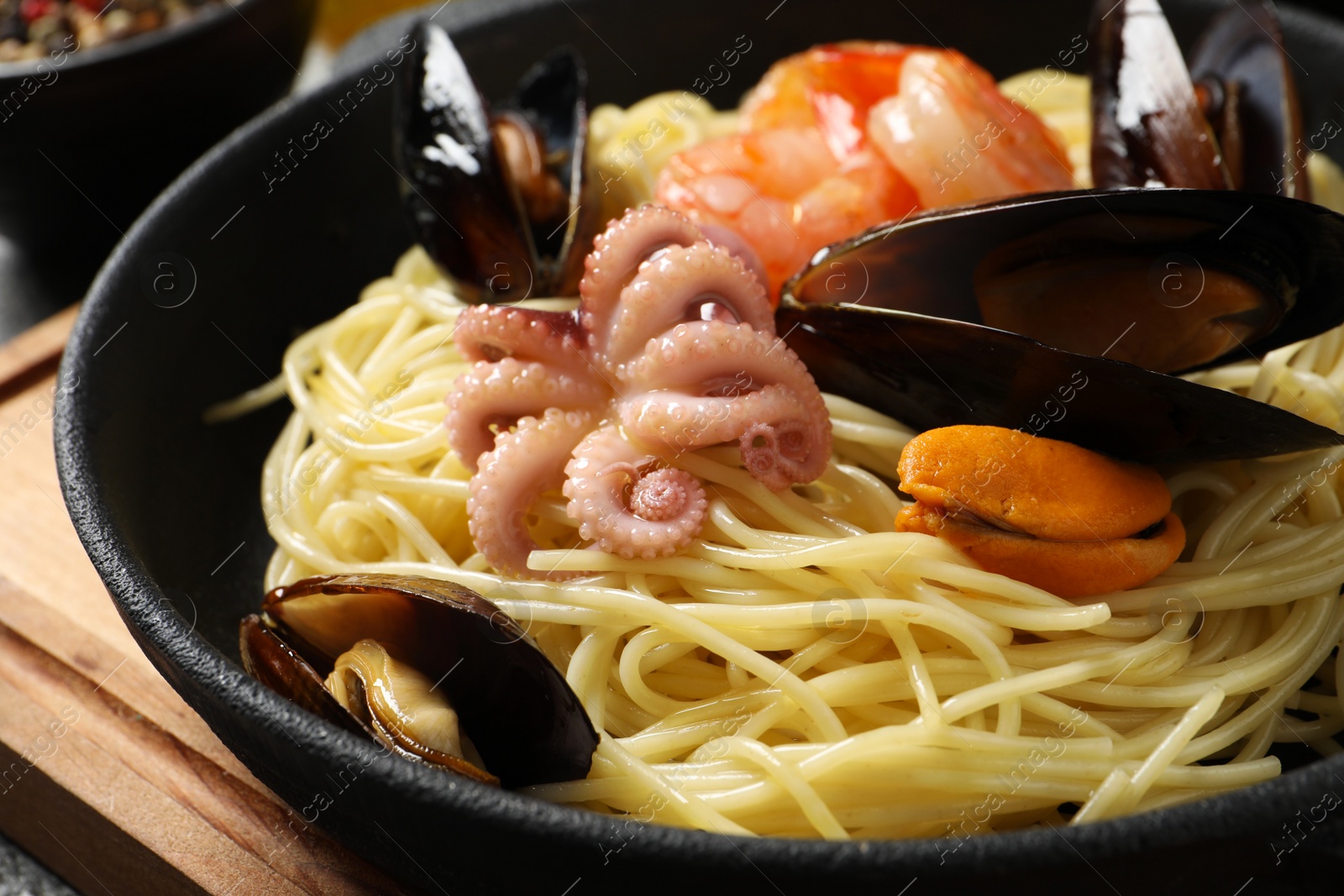 Photo of Delicious pasta with sea food in frying pan, closeup