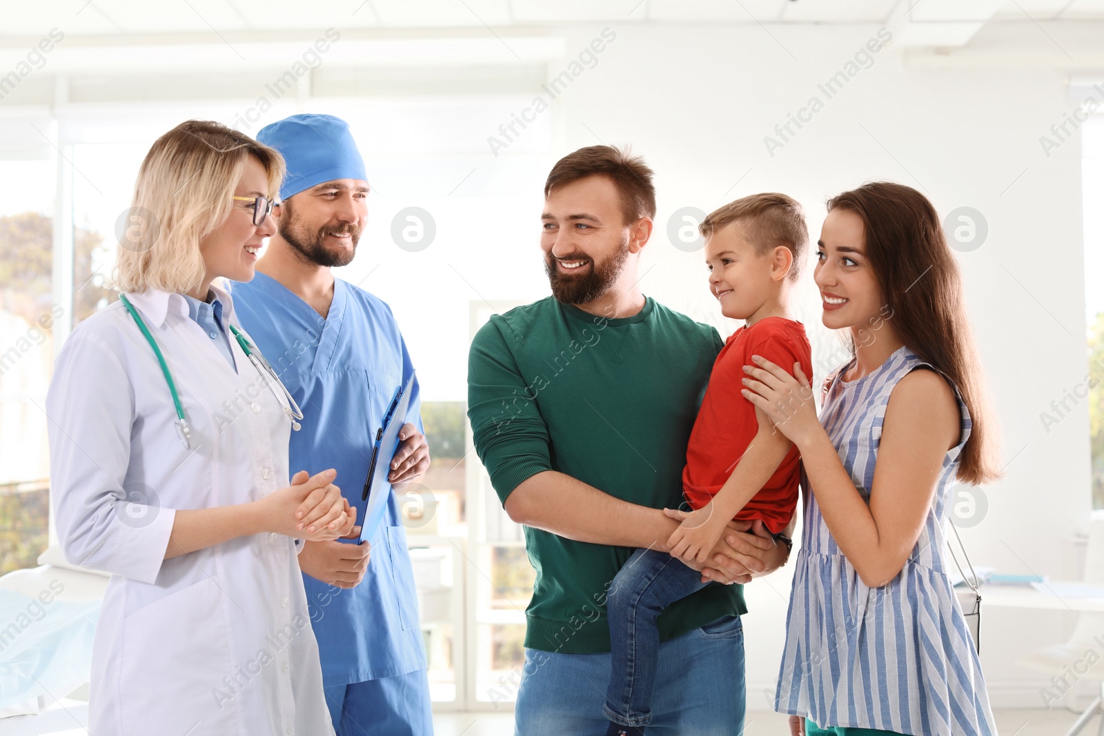 Photo of Little boy with parents visiting children's doctors in hospital