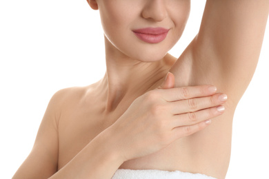 Photo of Young beautiful woman showing armpit with smooth clean skin on white background, closeup