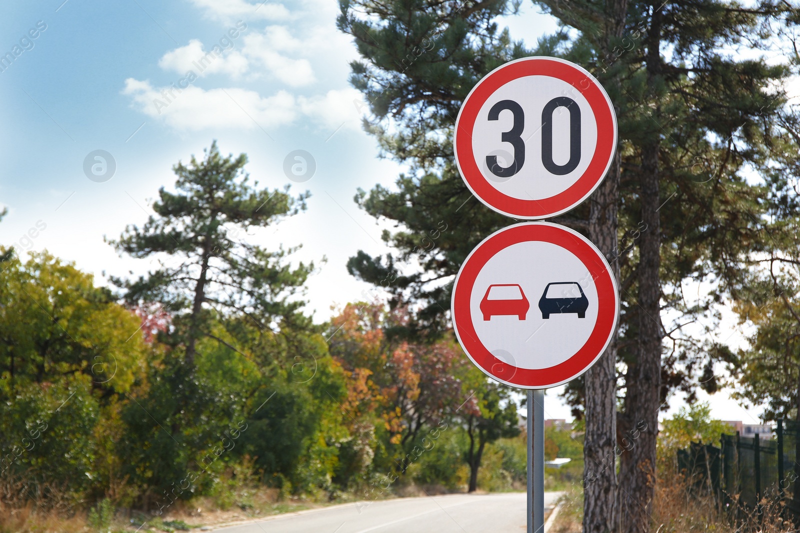 Photo of Post with road signs Maximum Speed 30 and No Overtaking outdoors. Space for text