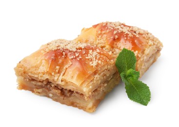 Photo of Eastern sweets. Pieces of tasty baklava with mint isolated on white