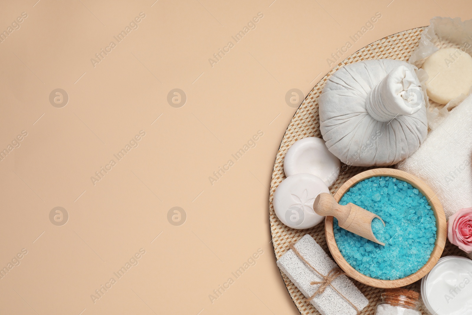 Photo of Composition of herbal bag and spa products on beige background, top view. Space for text