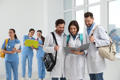 Photo of Team of medical students in college hallway, space for text