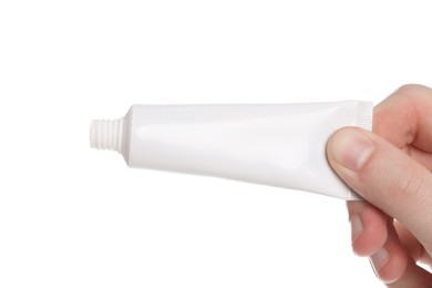Photo of Man holding tube of ointment on white background, closeup