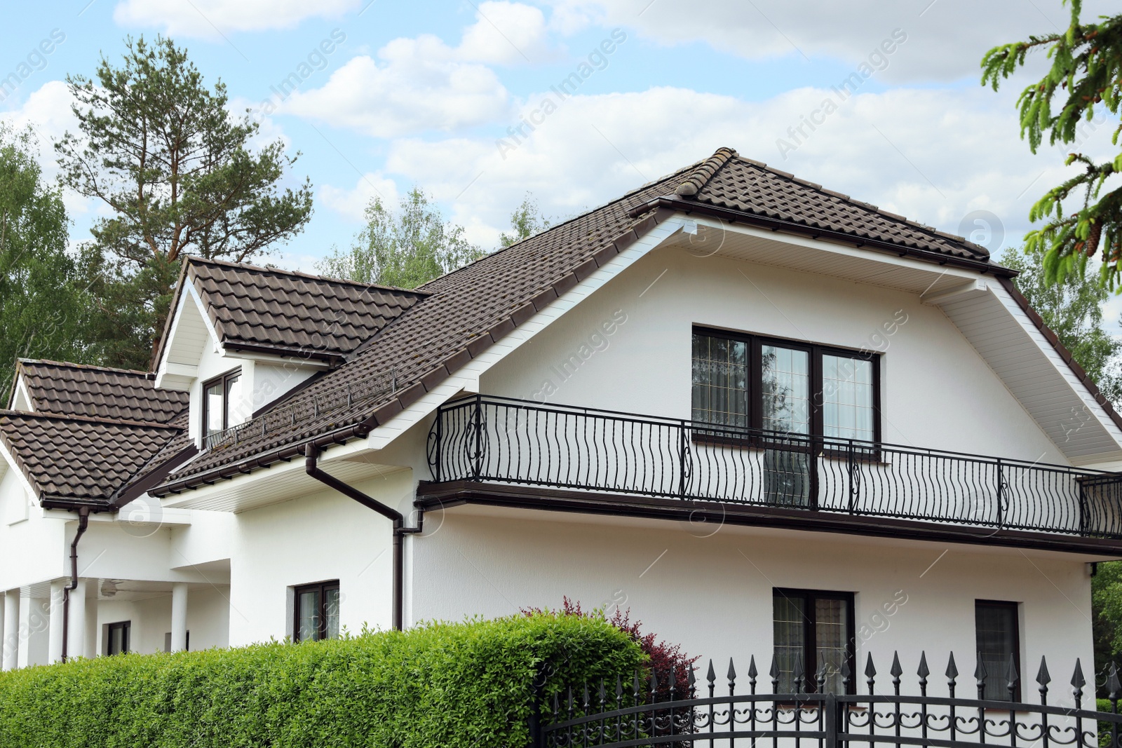 Photo of Modern building with brown roof outdoors on sunny day