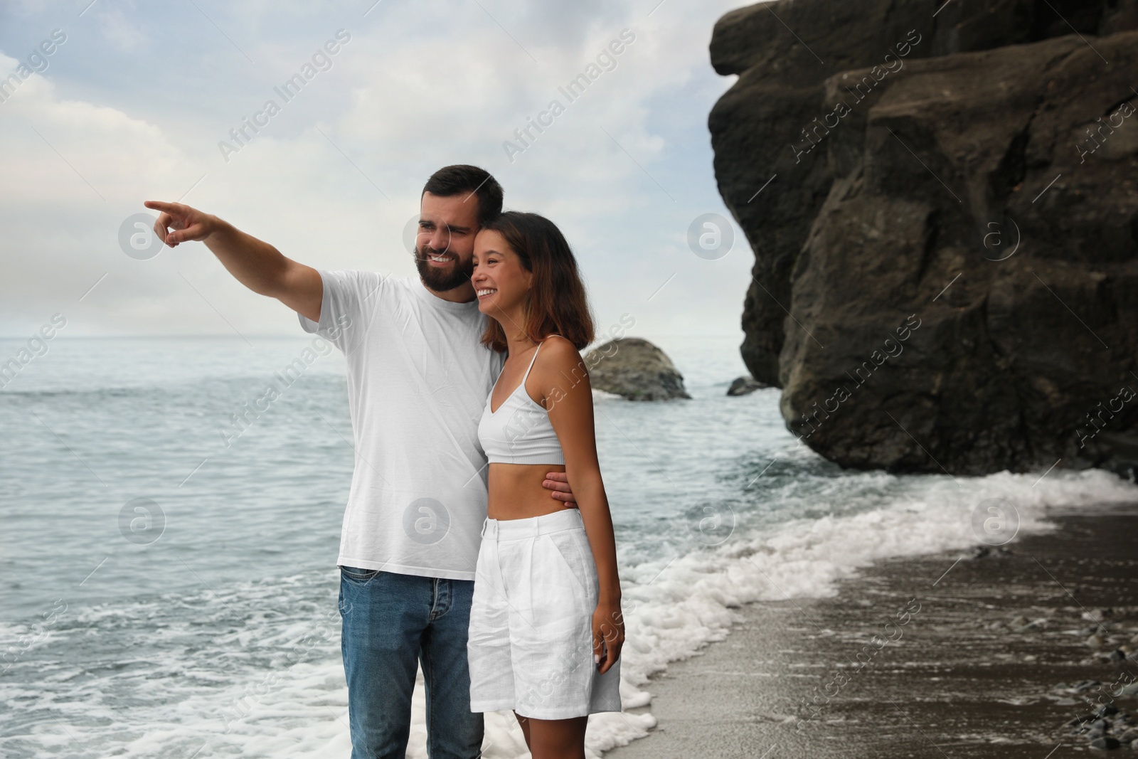 Photo of Happy young couple on beach near sea