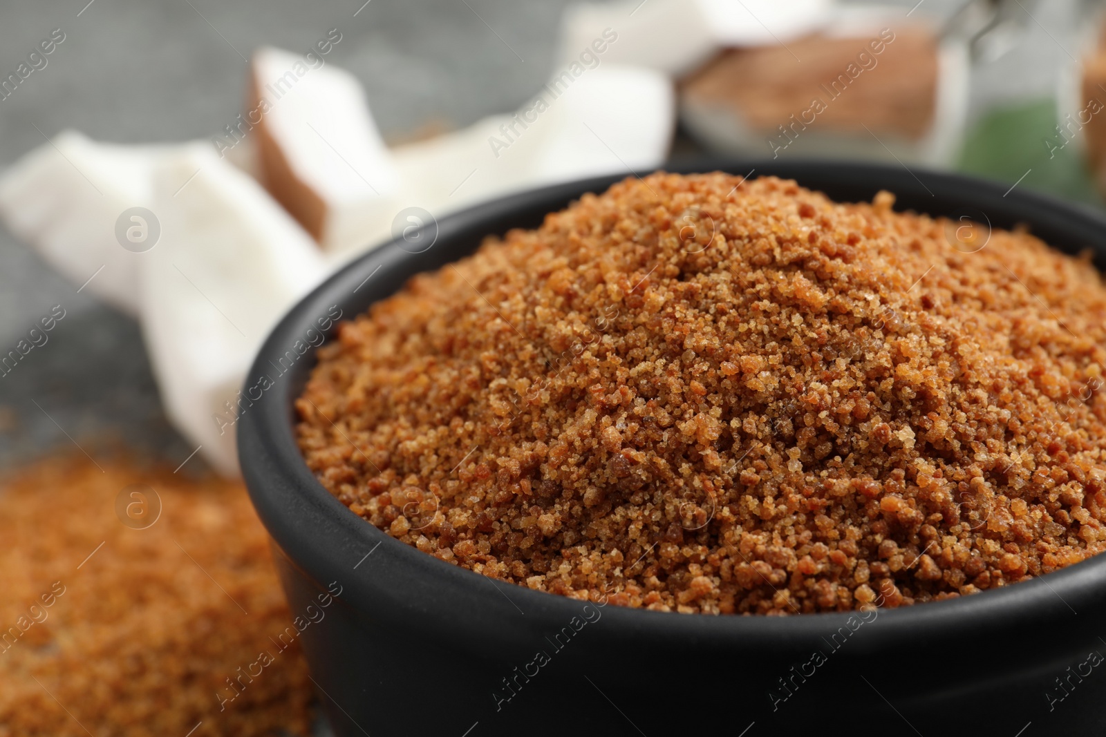 Photo of Natural coconut sugar in ceramic bowl, closeup