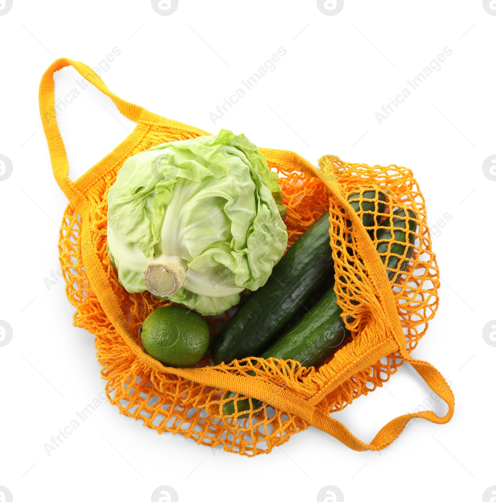 Photo of String bag with different vegetables isolated on white, top view