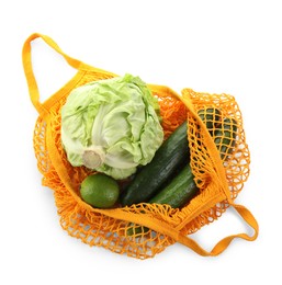 Photo of String bag with different vegetables isolated on white, top view