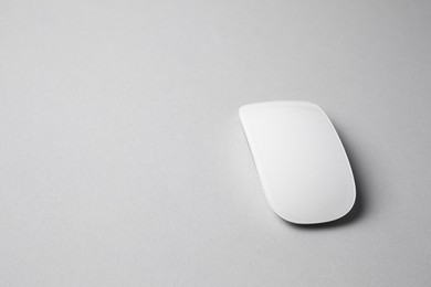 One wireless mouse on grey background. Space for text