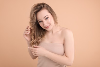 Portrait of beautiful woman on beige background