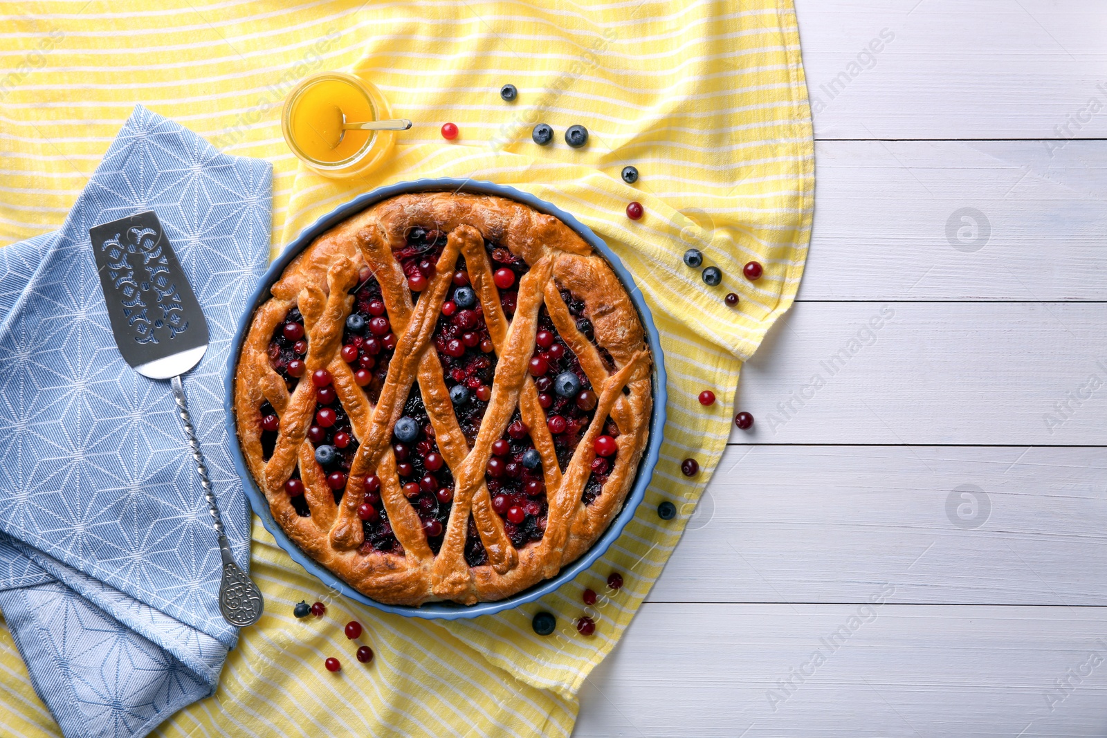 Photo of Delicious currant pie and fresh berries on white wooden table, flat lay