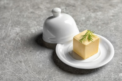 Dish with fresh butter on table. Space for text