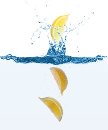 Fresh ripe lemon falling into water with splashes on white background