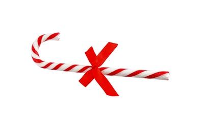 Photo of Candy cane with bow on white background, top view. Traditional Christmas treat