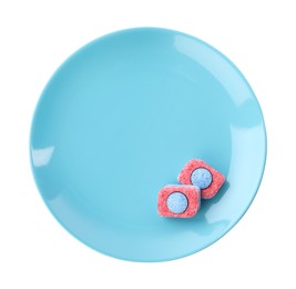 Photo of Light blue plate with dishwasher detergent tablets on white background, top view