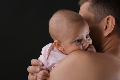 Photo of Father with his little baby on black background