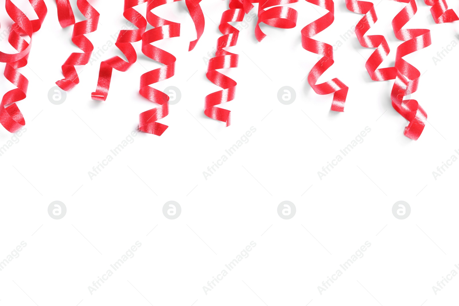 Photo of Red serpentine streamers on white background, top view