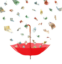 Image of Euro banknotes falling into red umbrella on white background