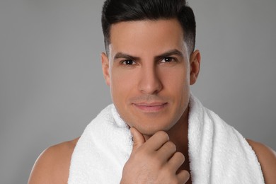 Handsome man after shaving on grey background, closeup