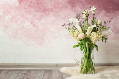Photo of Vase with bouquet of beautiful flowers on floor