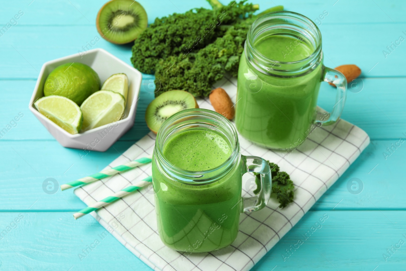 Photo of Tasty fresh kale smoothie on light blue wooden table