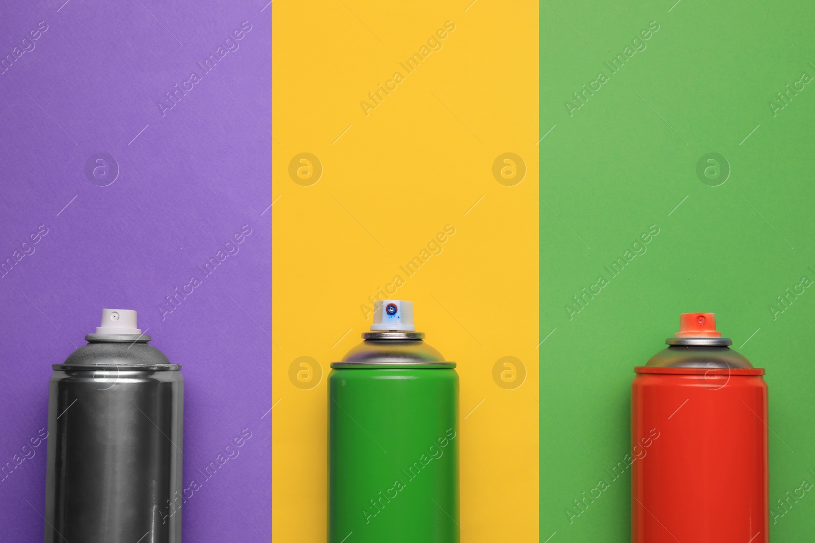 Photo of Cans of different spray paints on color background, flat lay with space for text. Graffiti supplies