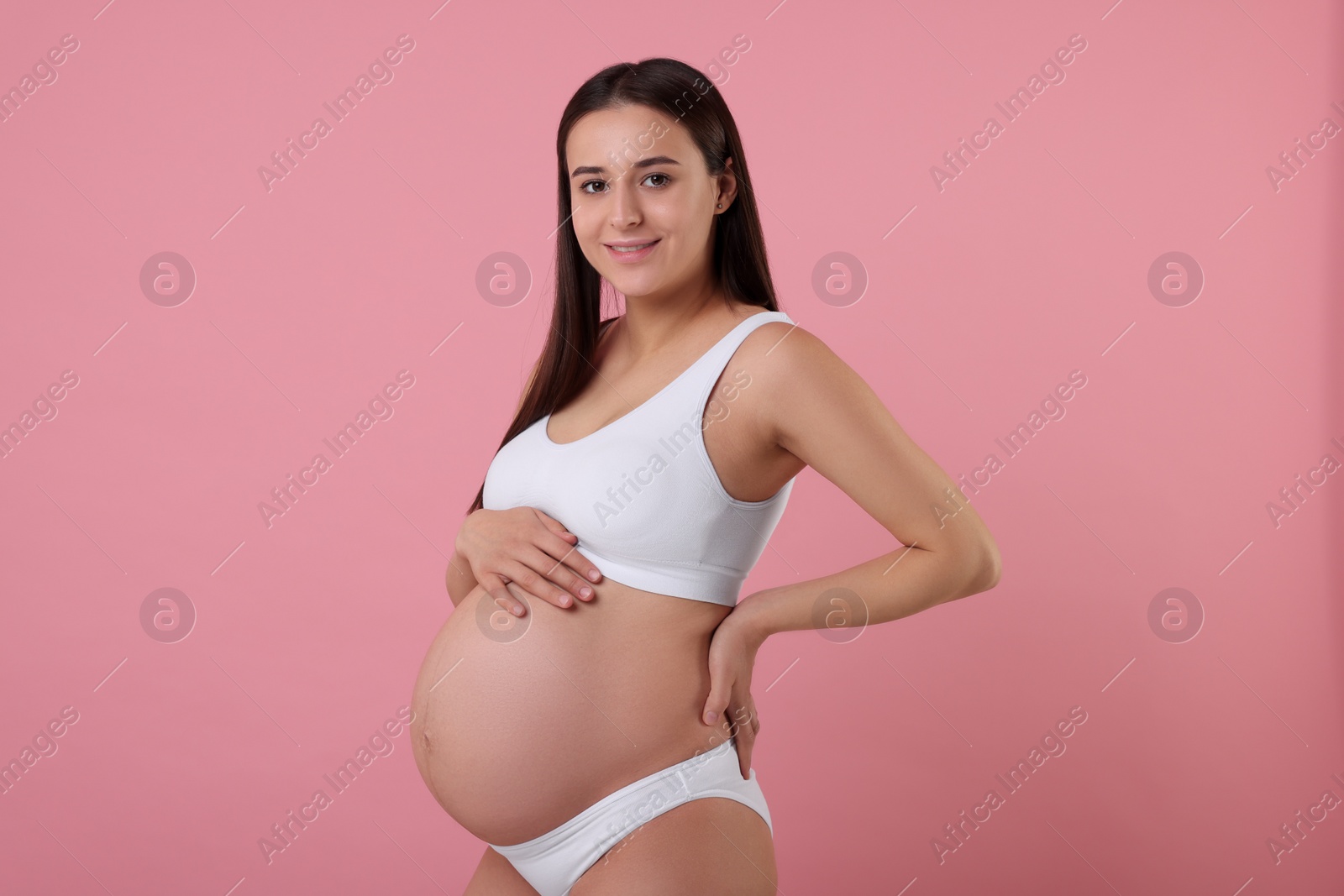 Photo of Beautiful pregnant woman in stylish comfortable underwear on pink background