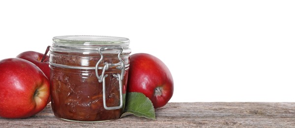 Photo of Delicious apple jam in jar and fresh fruits on wooden table against white background, space for text