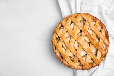 Photo of Delicious traditional apple pie on white table, top view. Space for text