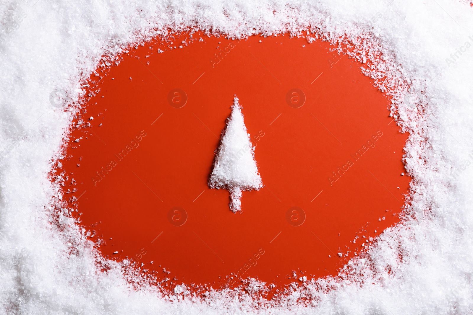 Photo of Frame and Christmas tree silhouette made of snow on color background, top view