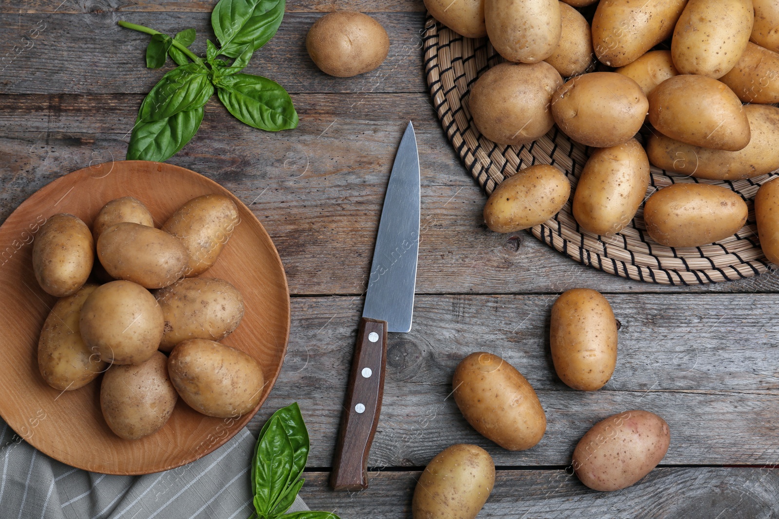 Photo of Flat lay composition with fresh ripe organic potatoes on wooden background