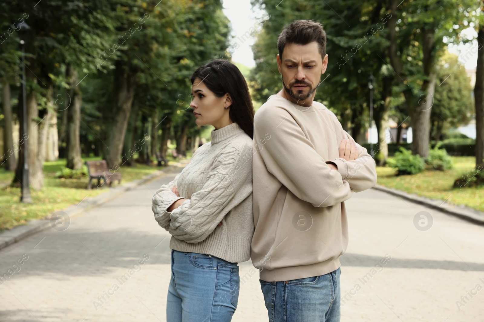 Photo of Upset arguing couple in park. Relationship problems