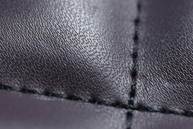 Photo of Purple leather with seam as background, closeup