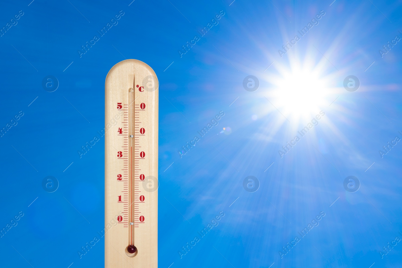 Image of Weather thermometer with high temperature outdoors on hot sunny day. Heat stroke warning