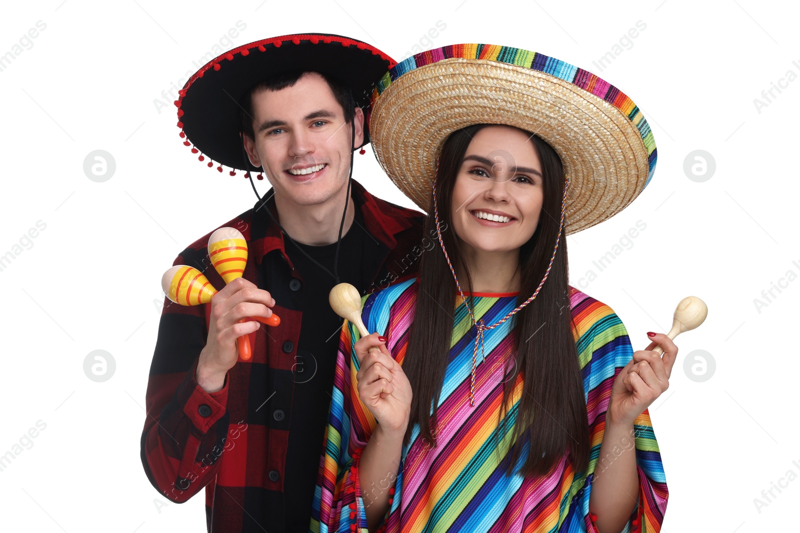 Photo of Lovely couple in Mexican sombrero hats with maracas on white background