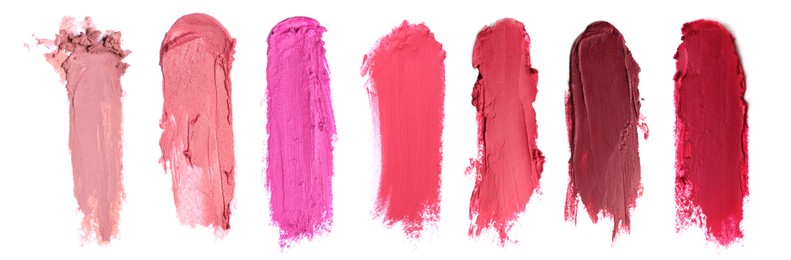 Smears of different beautiful lipsticks on white background, top view. Banner design