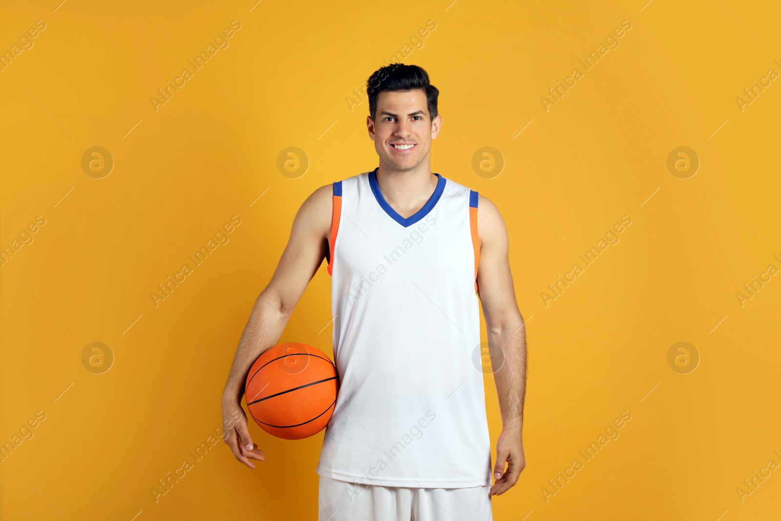 Photo of Basketball player with ball on yellow background