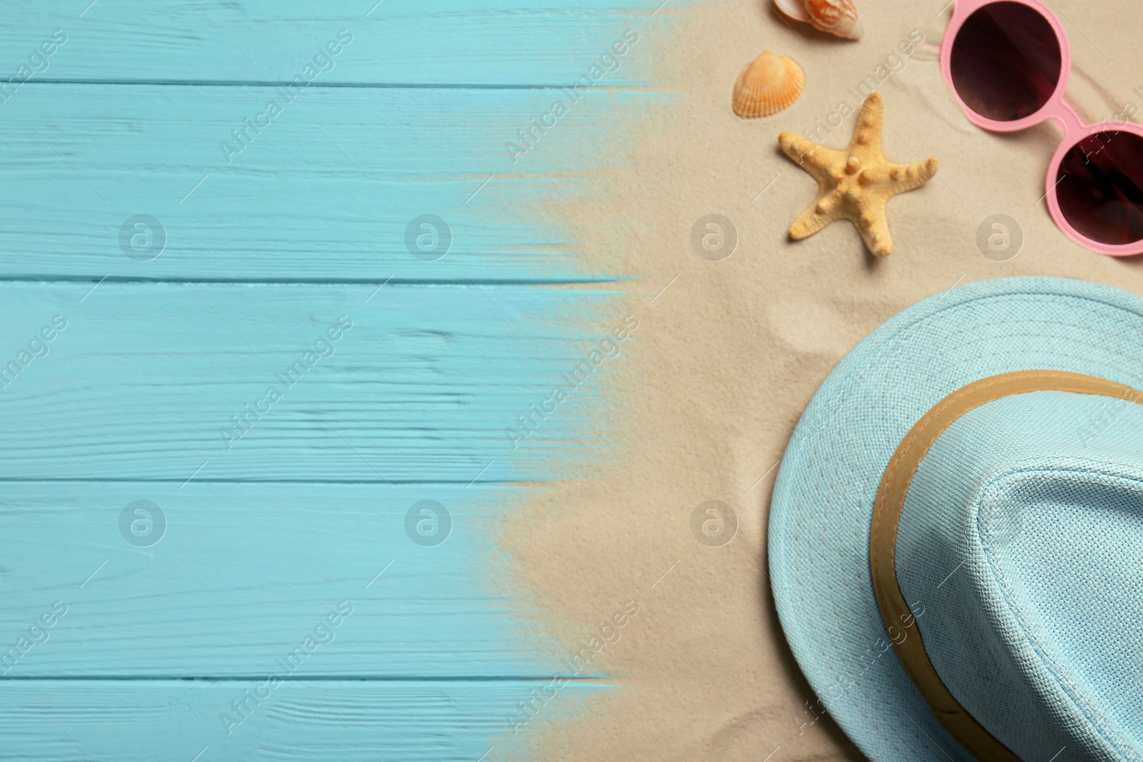 Photo of Flat lay composition with beach objects, sand and space for text on wooden background