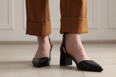 Photo of Businesswoman in elegant leather shoes indoors, closeup